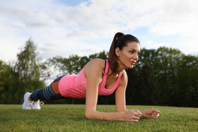Photo of Beautiful woman doing fitness exercise in morning outdoors