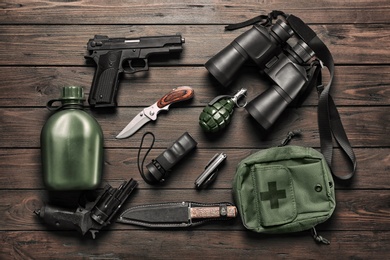 Photo of Set of military outfit on wooden background, flat lay