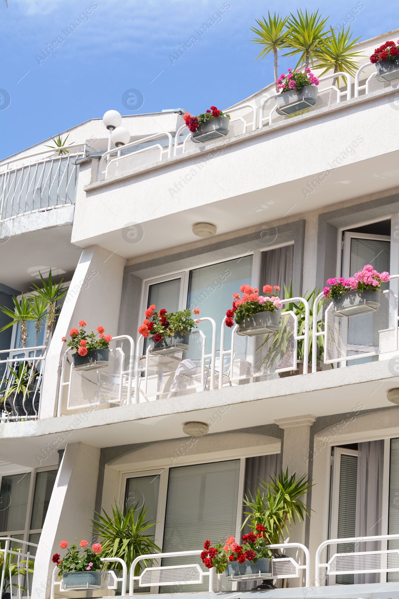 Photo of Exterior of beautiful residential building with balconies and flowers