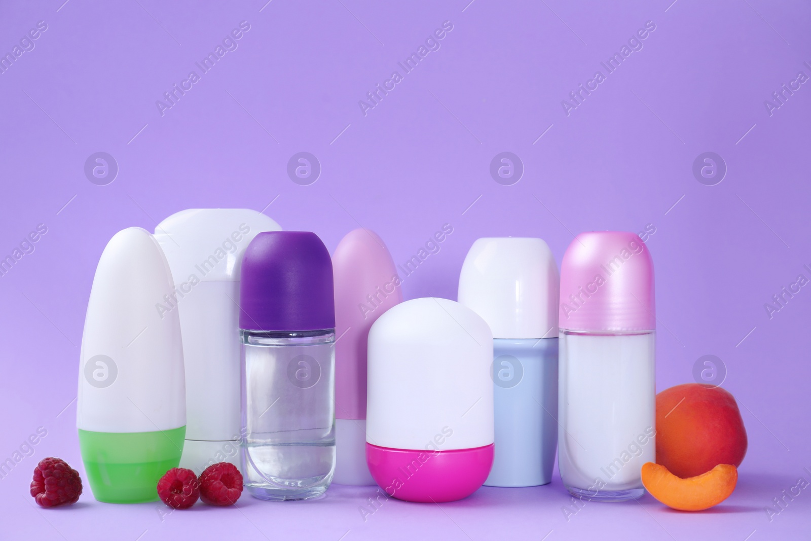 Photo of Composition with different female deodorants on purple background, space for text