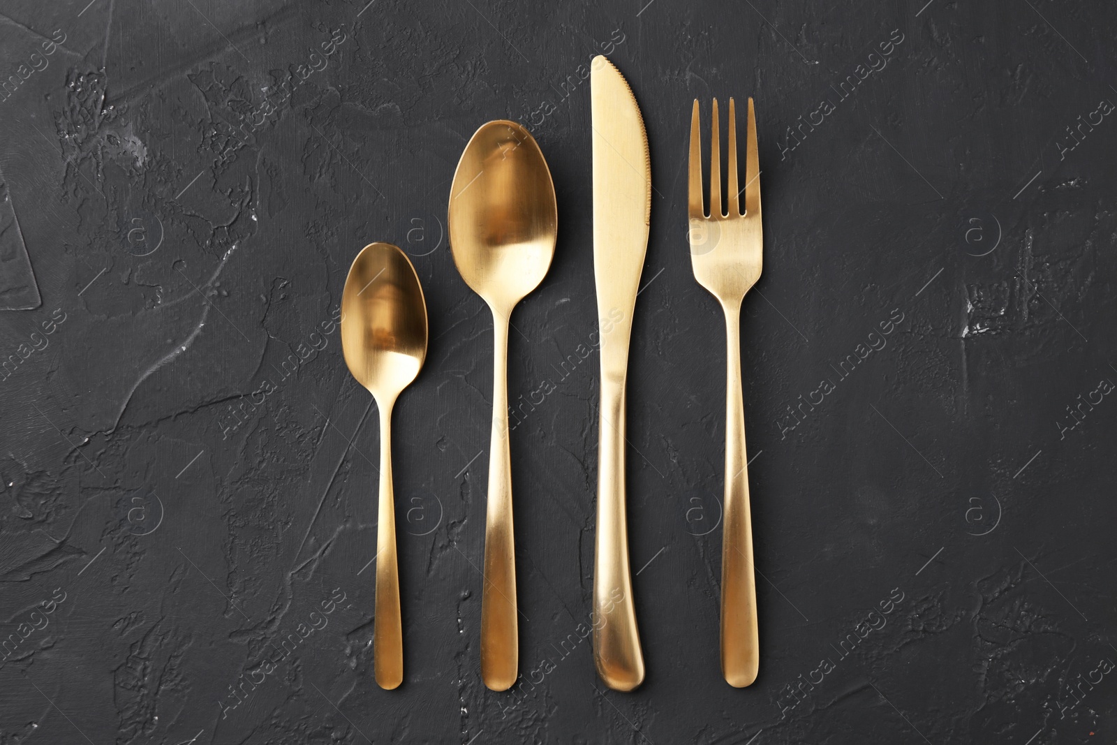 Photo of Beautiful cutlery set on black table, flat lay