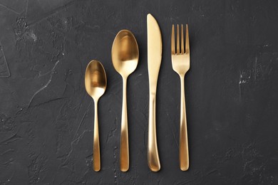 Photo of Beautiful cutlery set on black table, flat lay