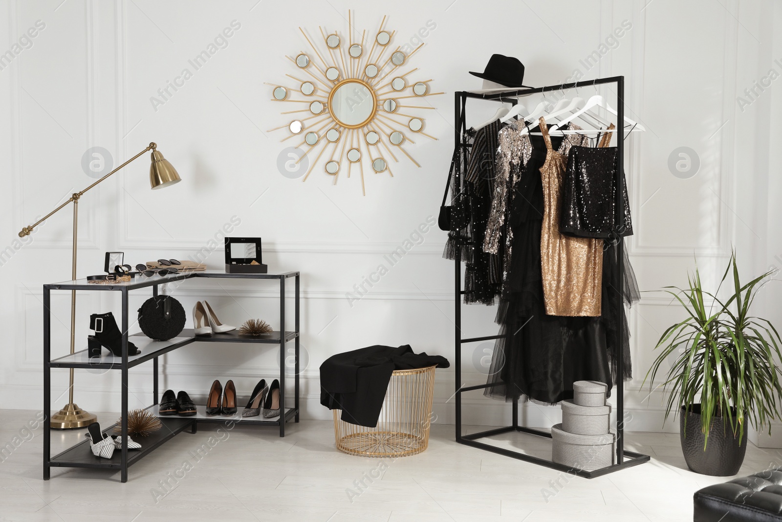 Photo of Stylish dressing room interior with trendy clothes, shoes and accessories