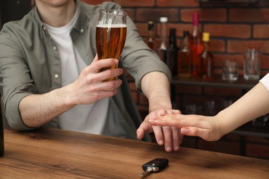 Photo of Woman stopping drunk man from taking car keys, closeup. Don't drink and drive concept