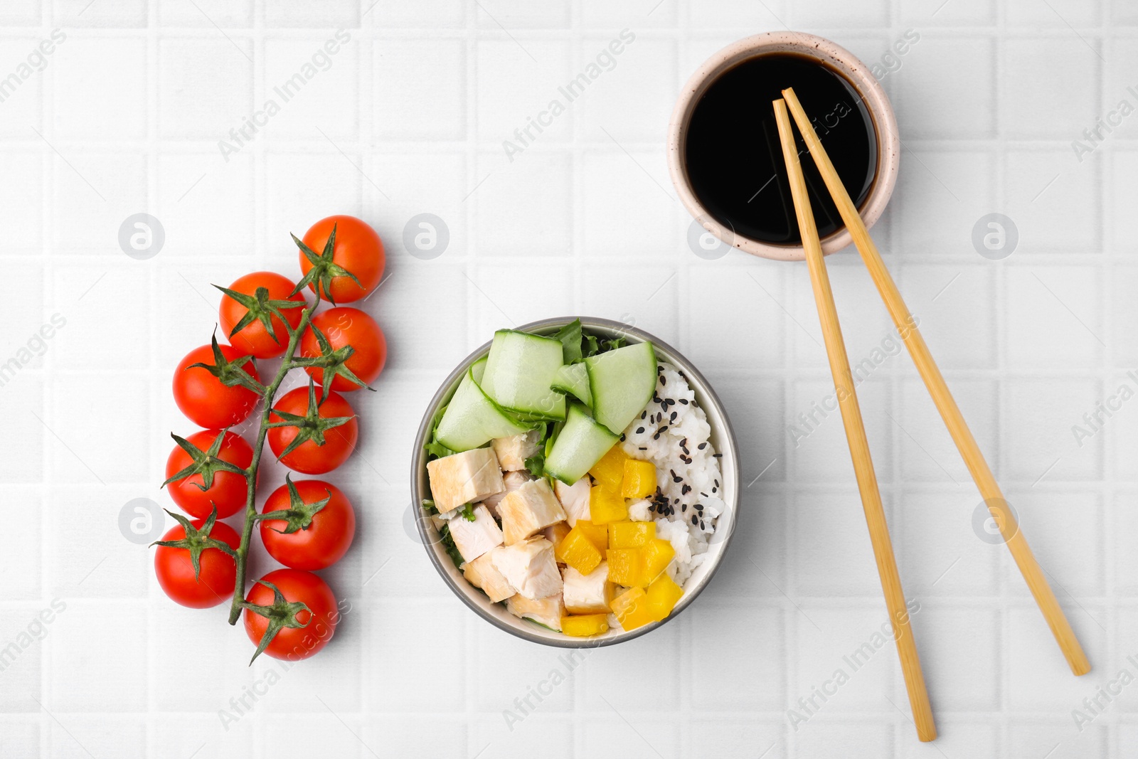 Photo of Delicious poke bowl with meat, rice and vegetables served on white table, flat lay