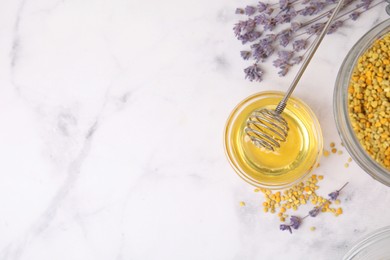 Photo of Fresh honey in bowl, dipper, bee pollen granules and lavender on light marble table, flat lay. Space for text