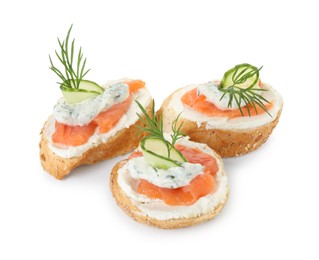 Photo of Tasty canapes with salmon, cucumber, cream cheese and dill isolated on white