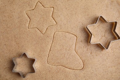 Homemade Christmas biscuits. Cookie cutters on raw dough, flat lay