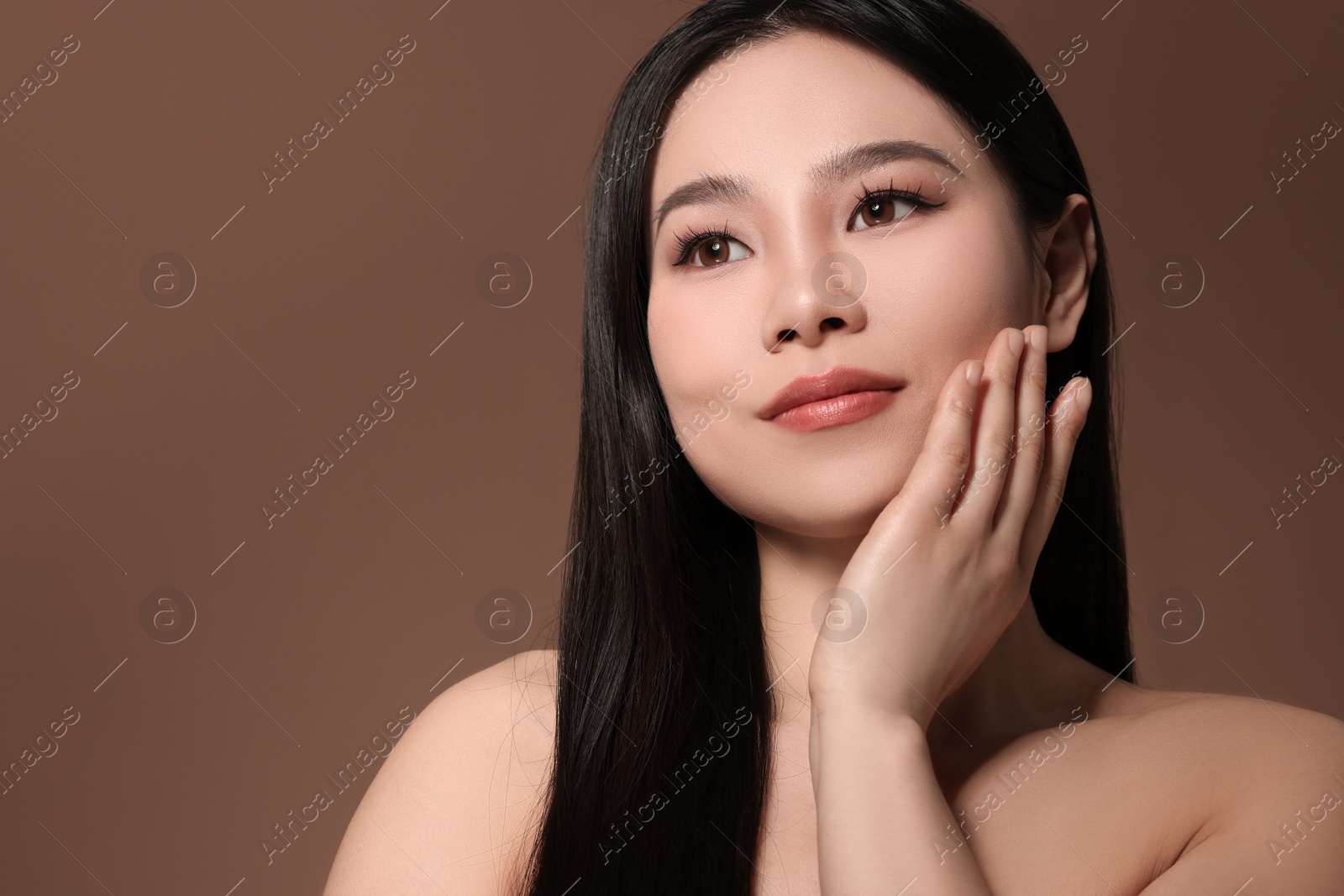 Photo of Portrait of beautiful woman on brown background, space for text