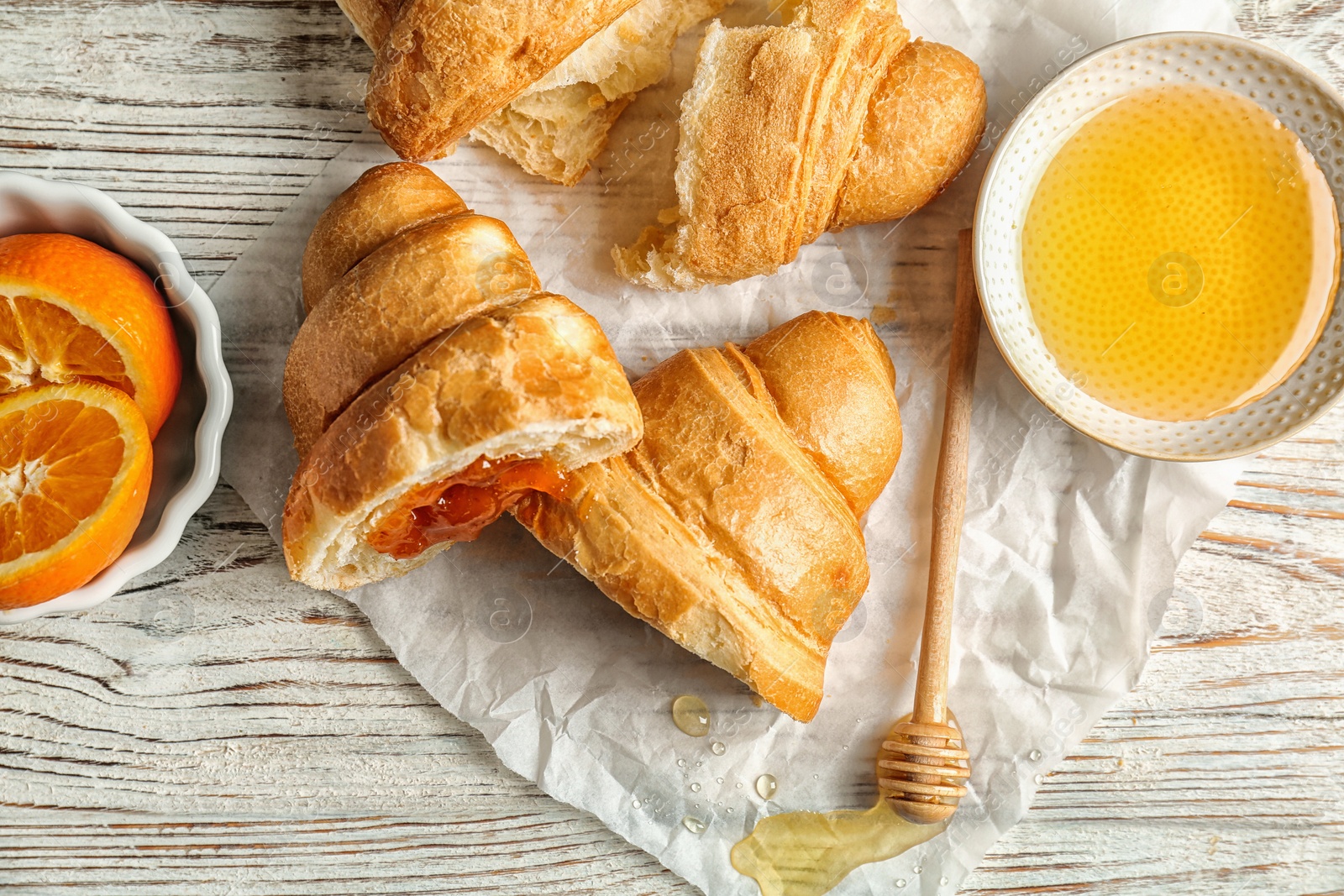 Photo of Tasty croissants served for breakfast on wooden table