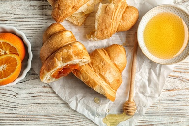 Tasty croissants served for breakfast on wooden table