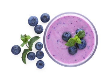 Glass of blueberry smoothie with fresh berries and mint on white background, top view