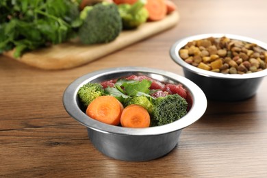 Pet food and natural ingredients on wooden table, closeup