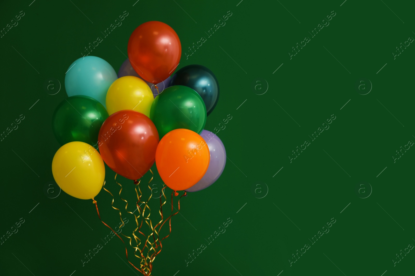 Photo of Bunch of bright balloons on color background, space for text. Celebration time