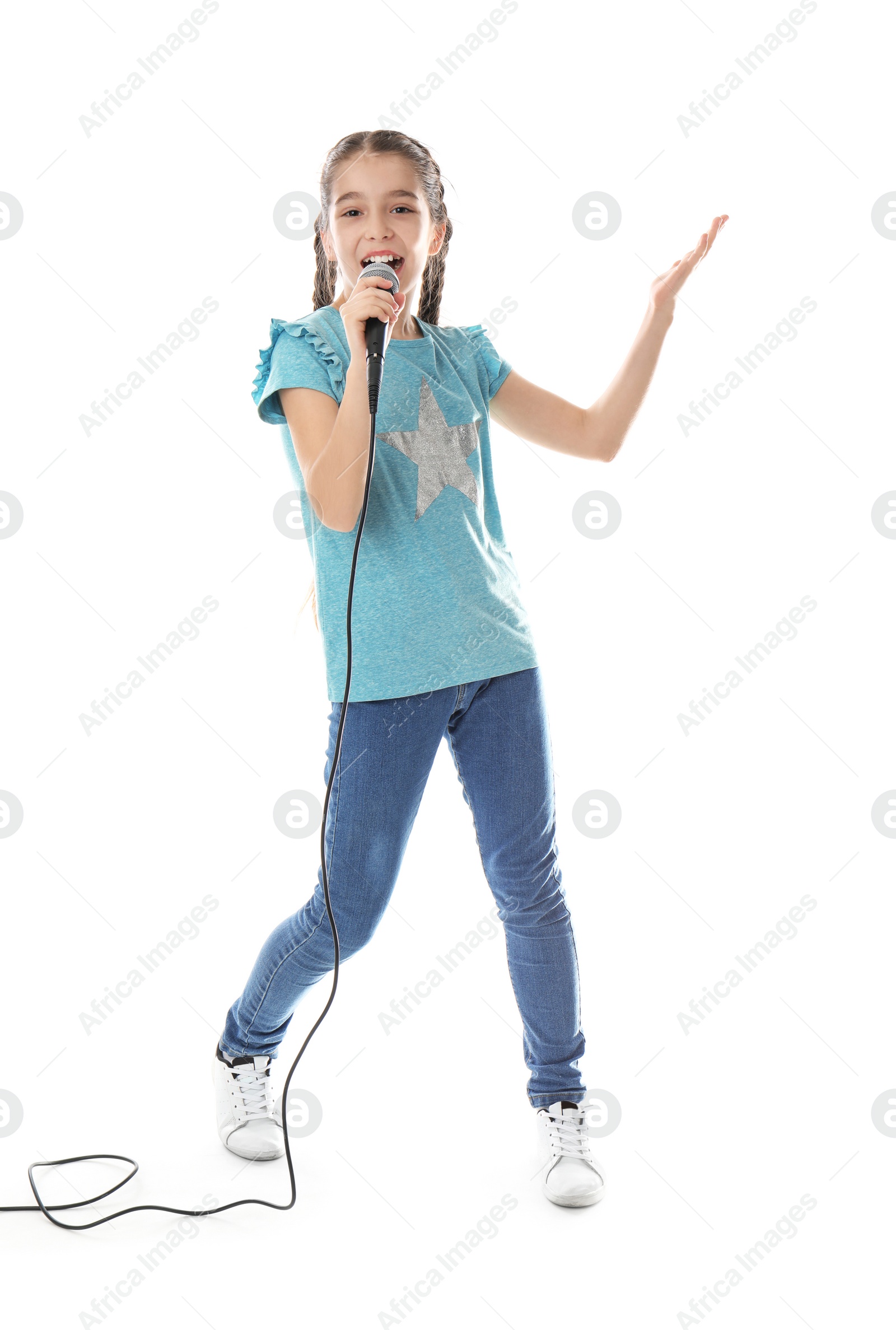 Photo of Cute girl singing in microphone on white background