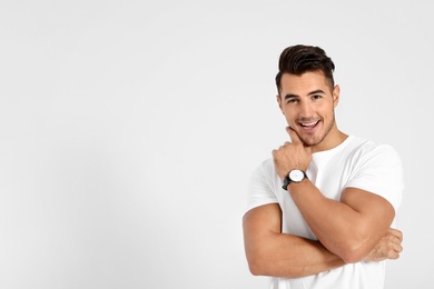 Portrait of handsome young man and space for text on white background