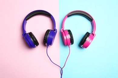 Stylish modern headphones on color background, flat lay