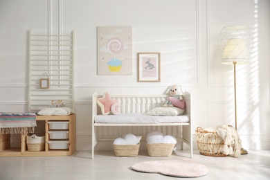 Baby room interior with stylish furniture and toys