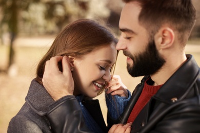 Photo of Portrait of cute young couple outdoors, closeup