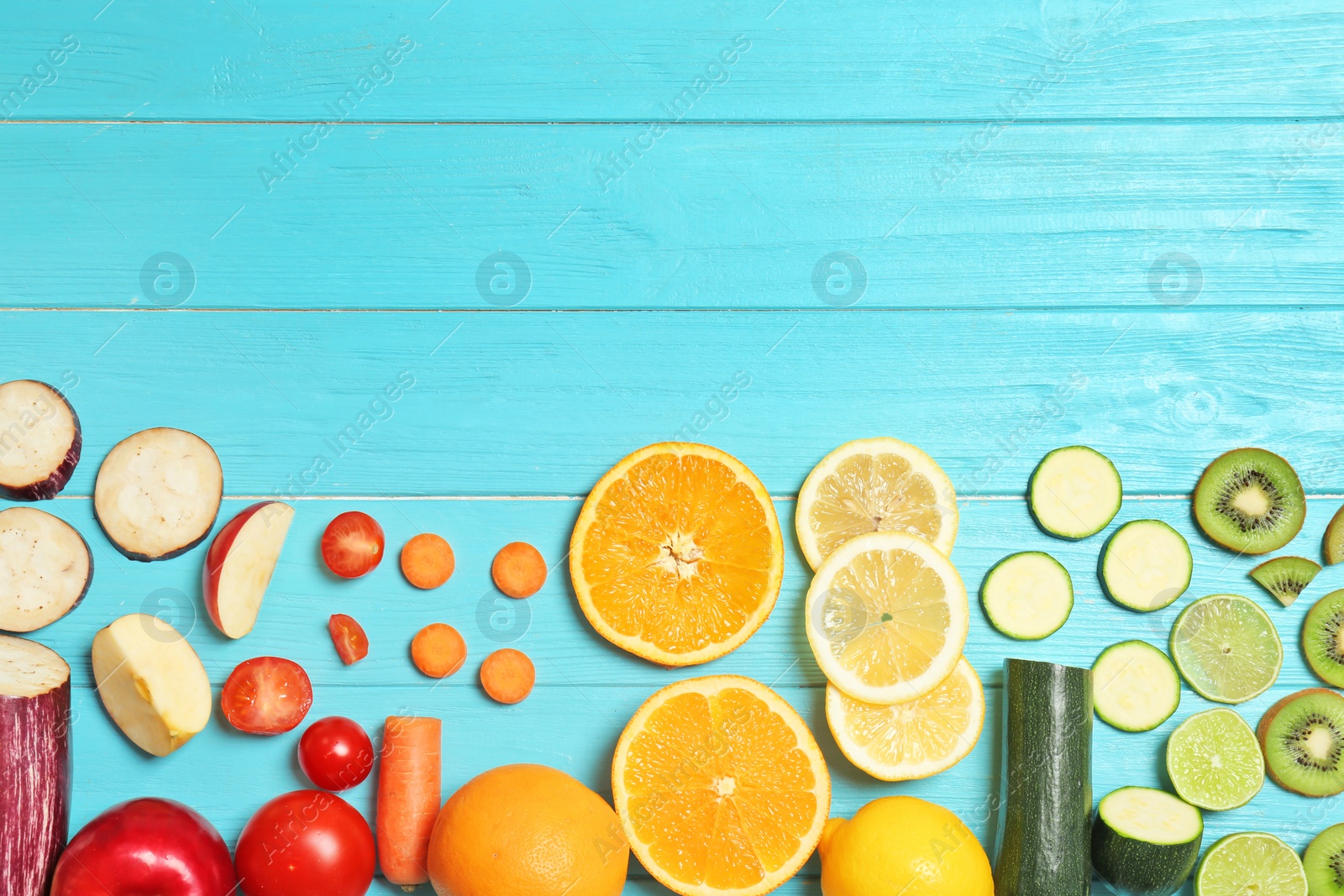 Photo of Rainbow composition with fresh vegetables and fruits on wooden background, flat lay