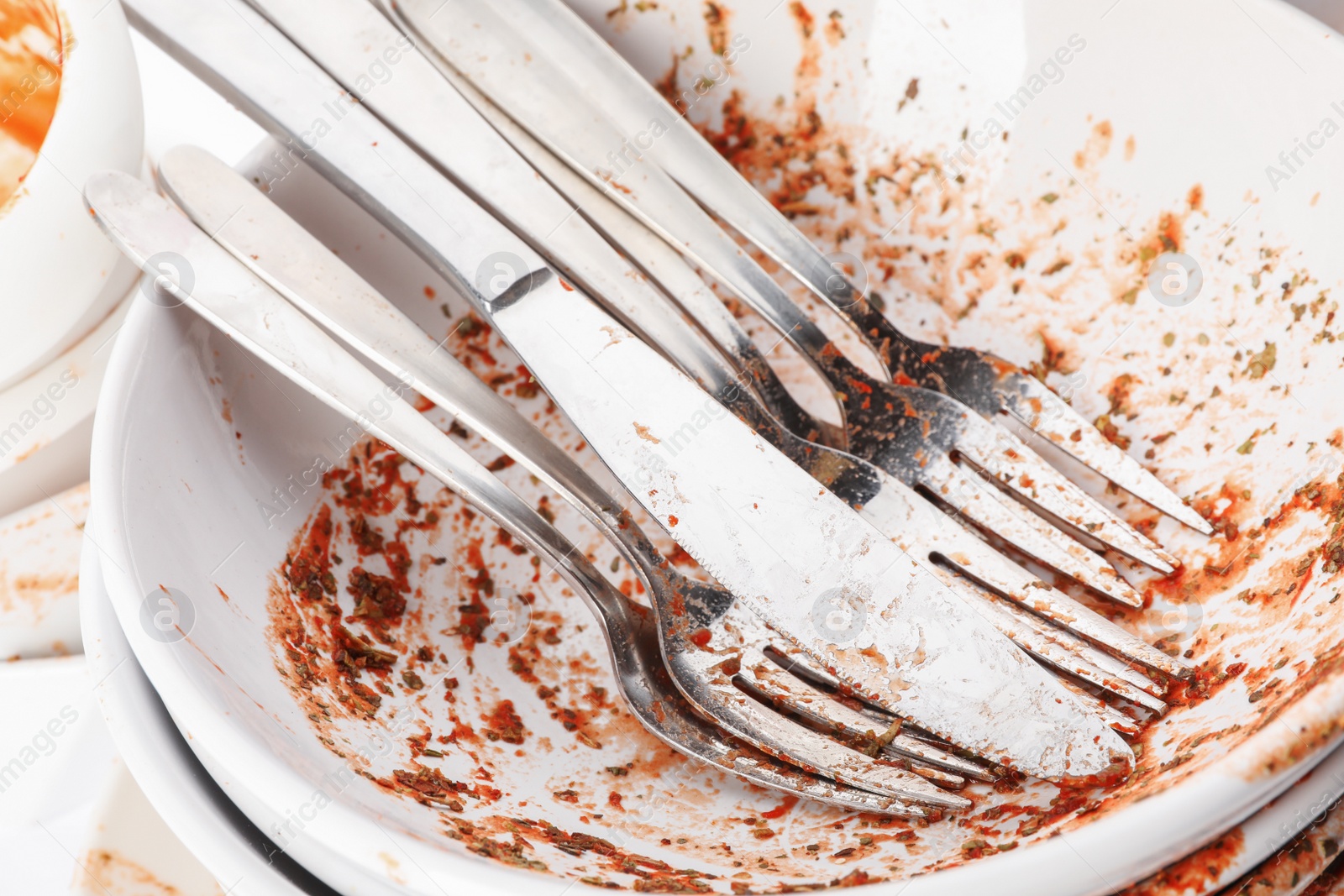 Photo of Pile of dirty dishes and cutlery, closeup