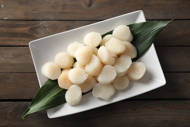 Fresh raw scallops on wooden table, top view