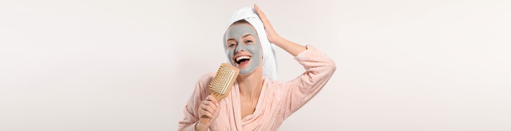 Image of Spa treatment. Happy woman with face mask and brush singing on white background, banner design