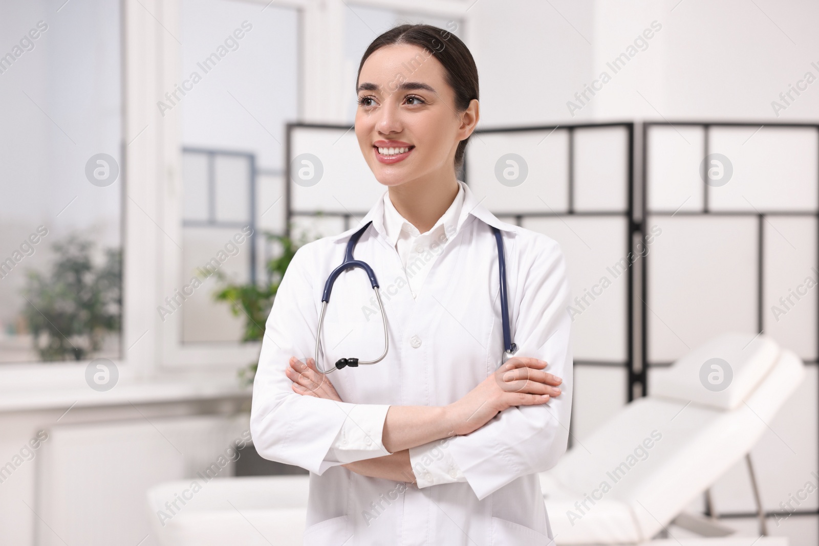 Photo of Medical consultant with glasses and stethoscope in clinic