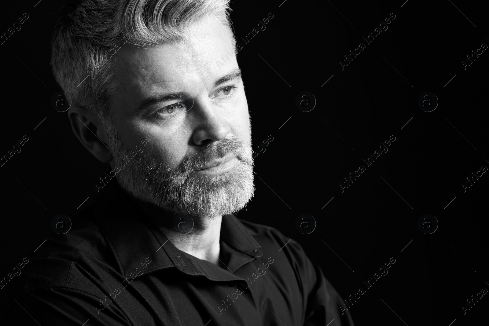 Photo of Portrait of handsome man on dark background, space for text. Black and white effect