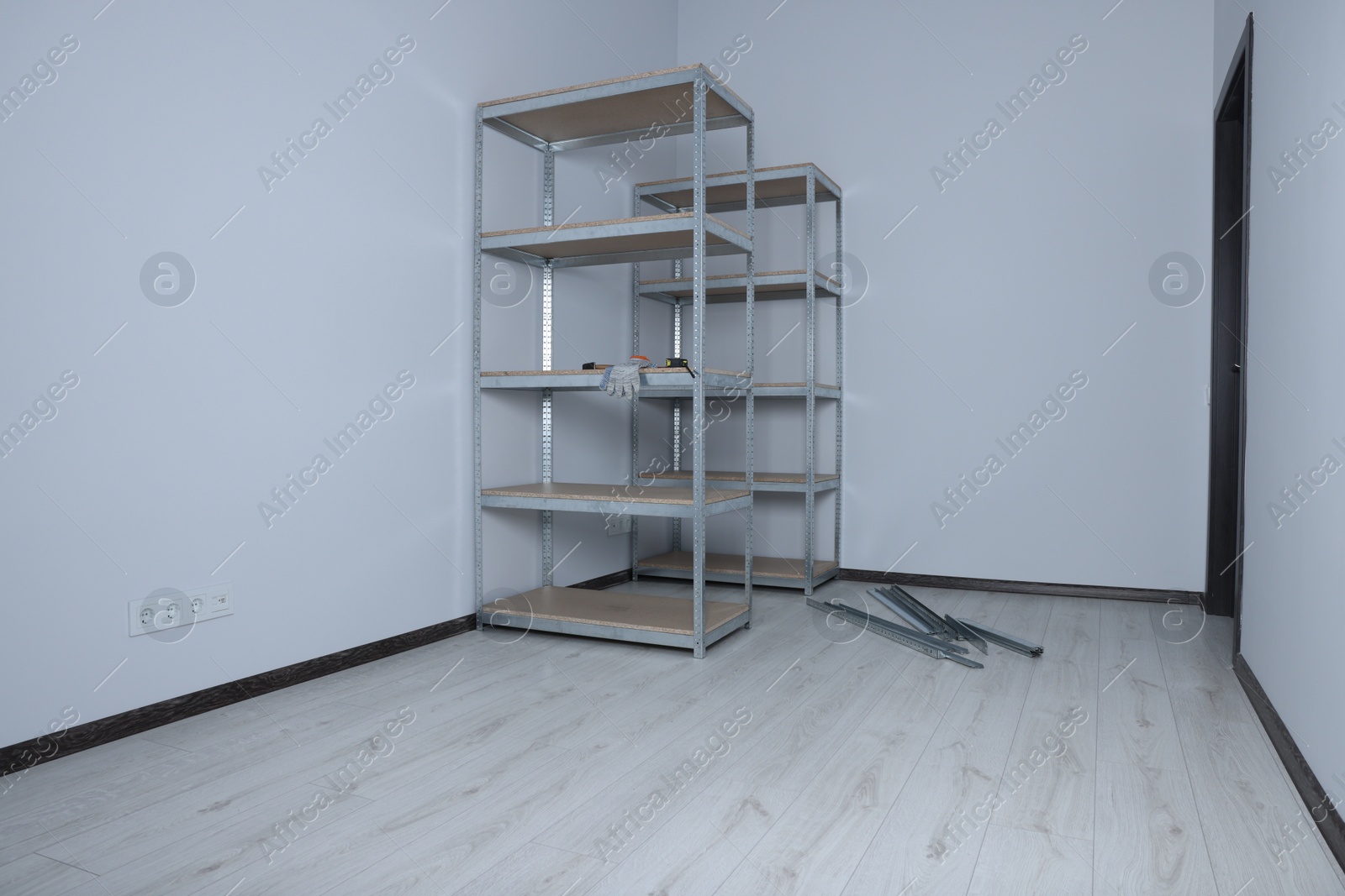 Photo of Office room with white walls and metal storage shelves