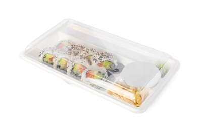 Photo of Food delivery. Delicious sushi rolls with soy sauce, ginger, wasabi and chopsticks in plastic container isolated on white