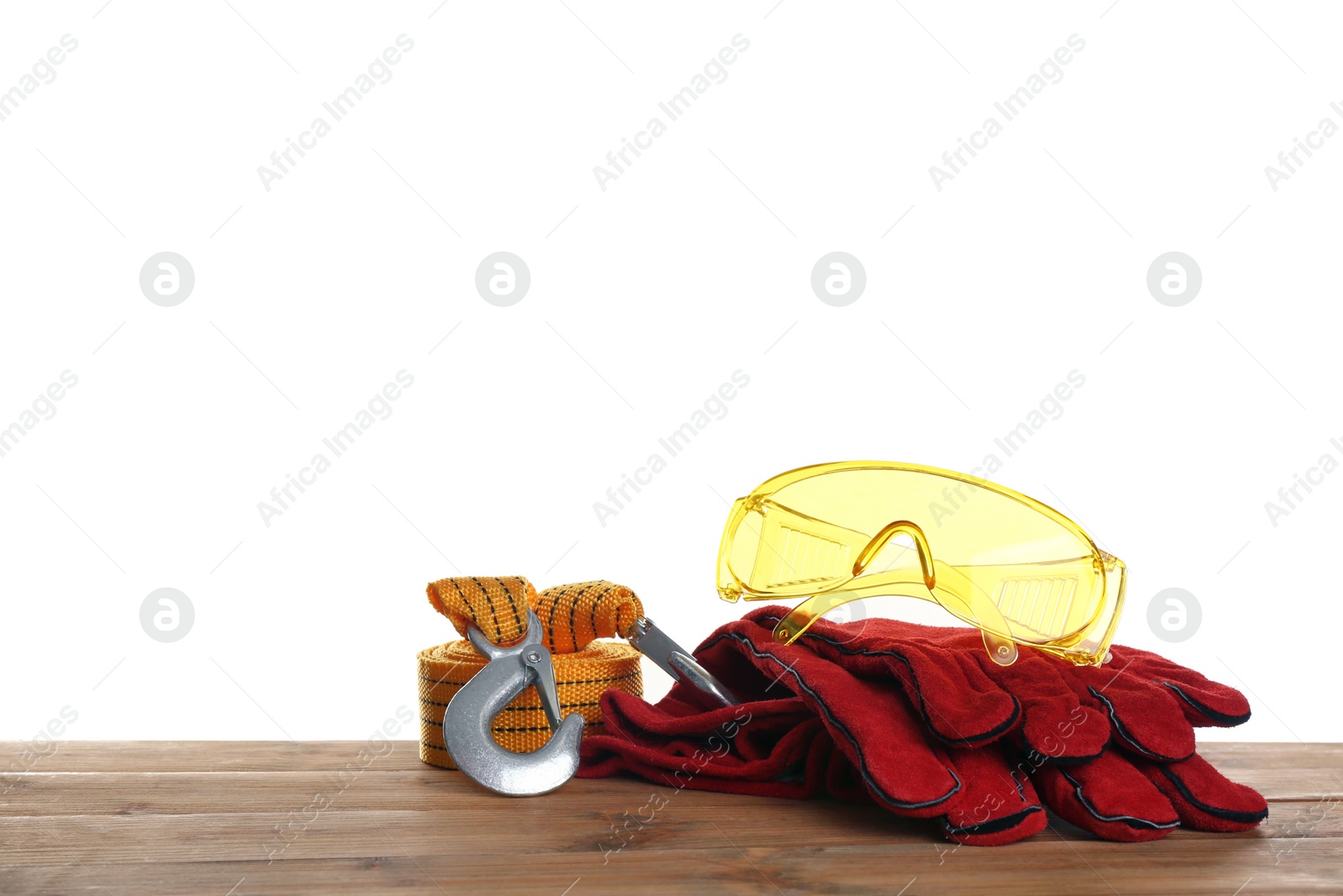 Photo of Set of safety equipment on table against white background