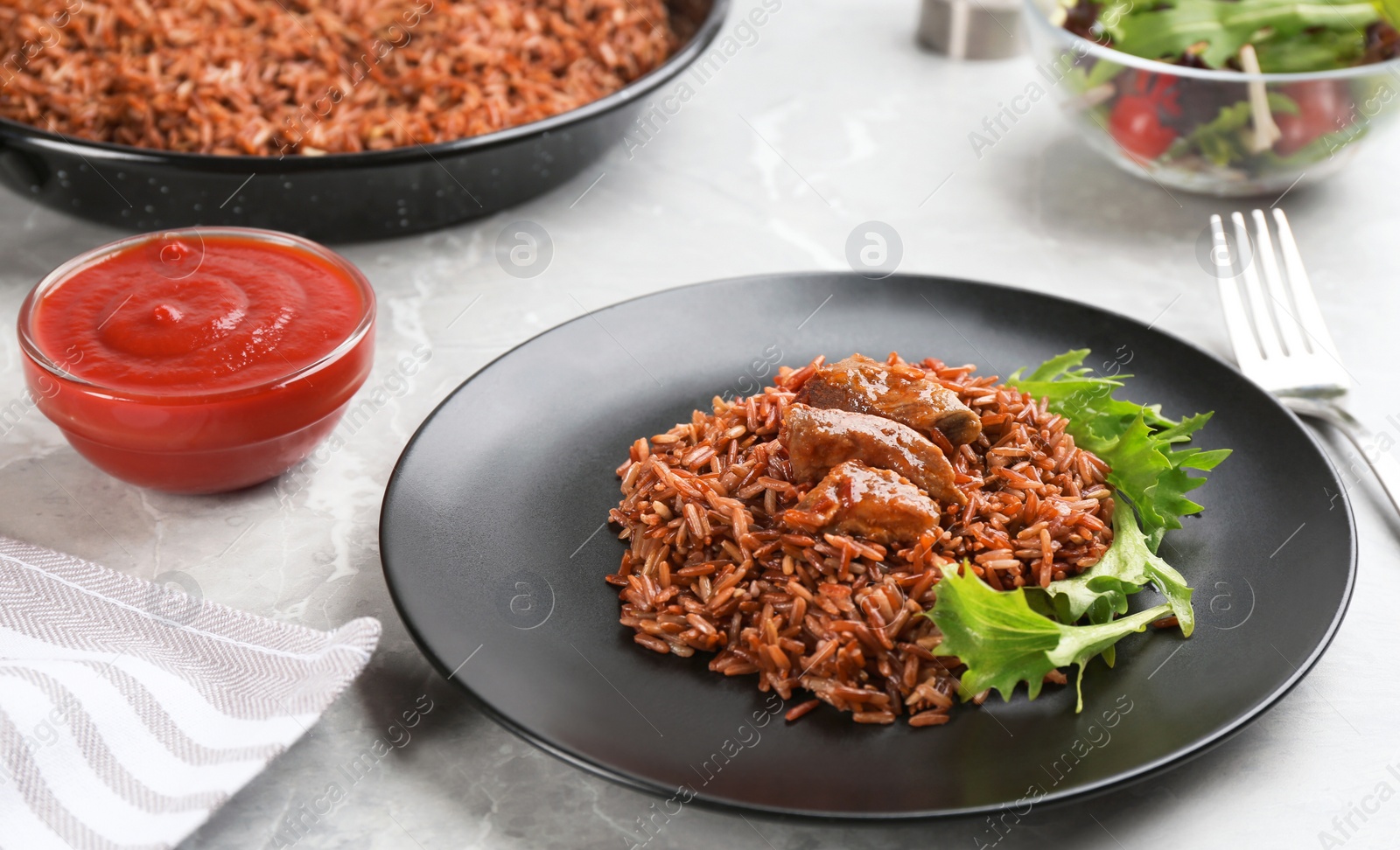 Photo of Tasty brown rice served on light grey table