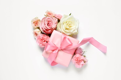 Photo of Gift box and beautiful flowers on white background, flat lay