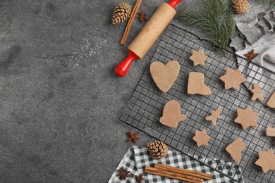 Homemade Christmas cookies. Flat lay composition with raw gingerbread biscuits on grey table, space for text