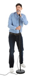 Handsome man singing in microphone on white background