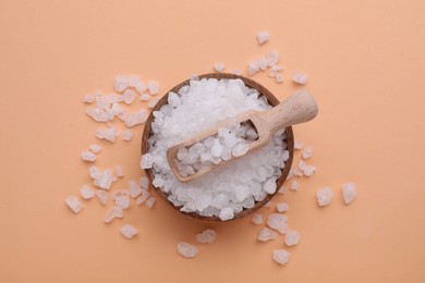 Photo of Bowl and scoop with sea salt on beige background, top view