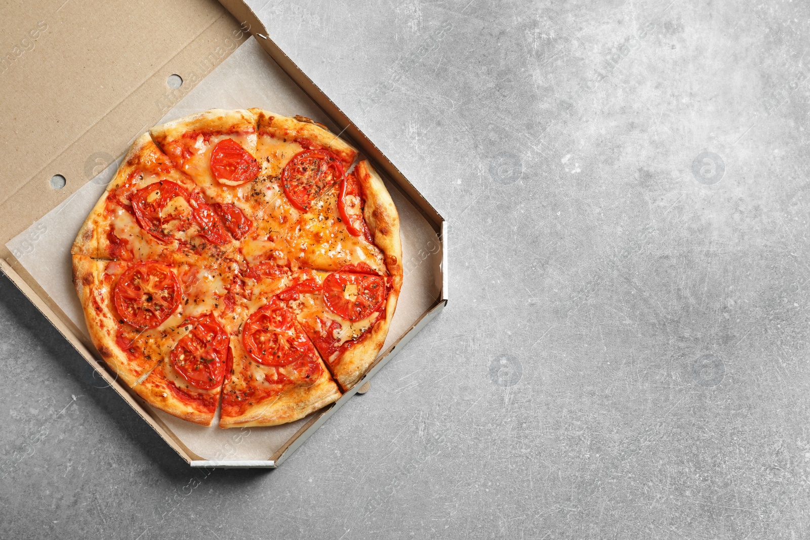 Photo of Cheese pizza in carton box on grey background, top view with space for text. Food delivery service