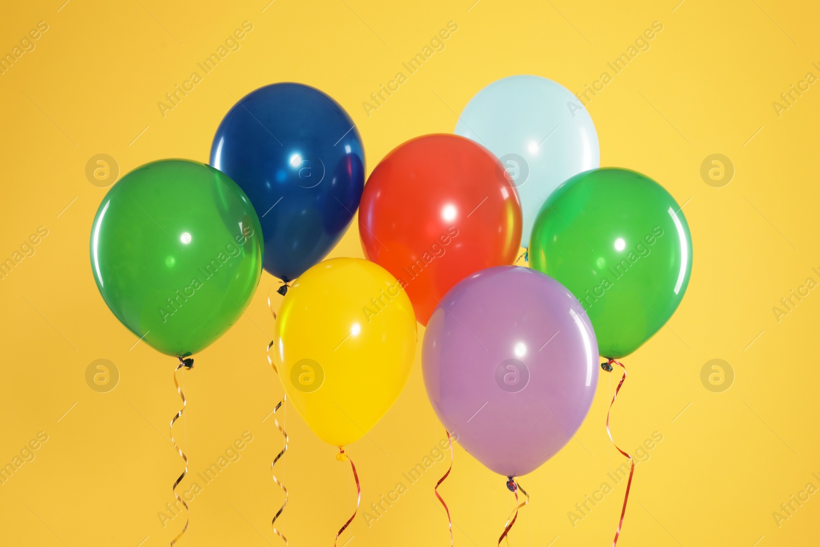 Photo of Bright balloons on color background. Celebration time