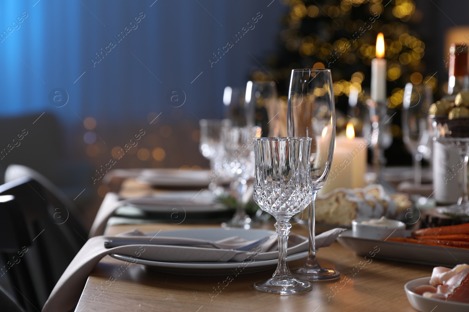 Photo of Christmas table setting with festive decor and dishware indoors