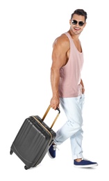 Photo of Young man walking with suitcase on white background