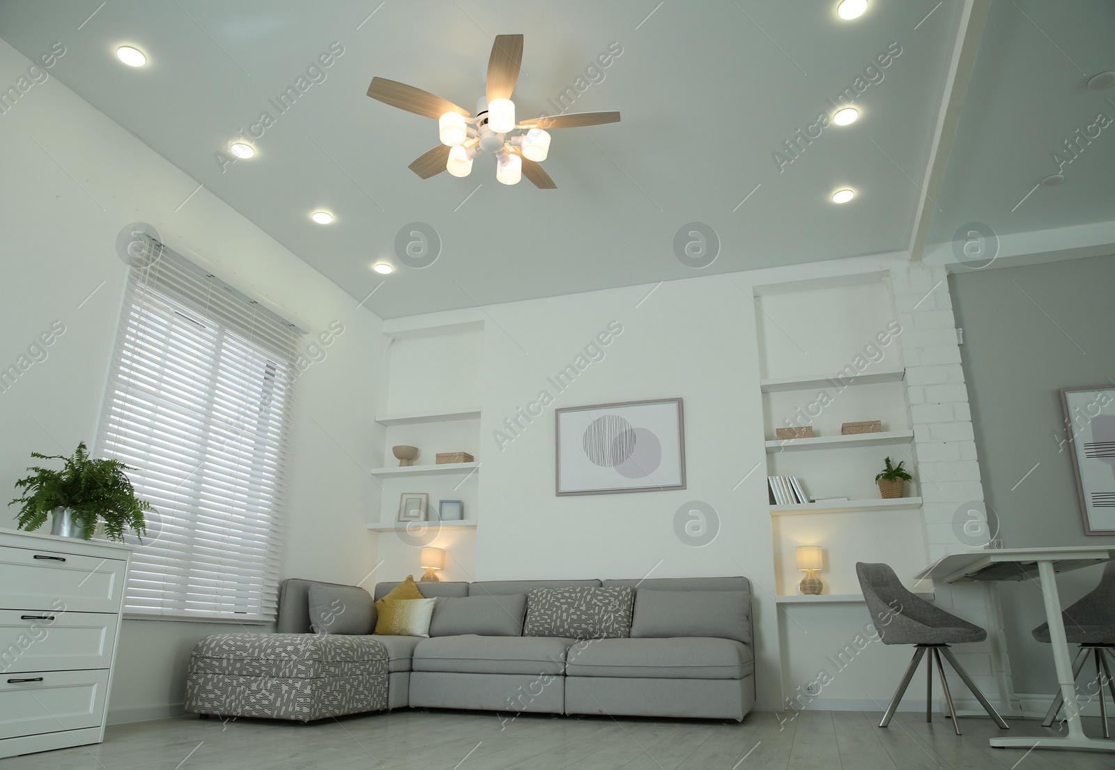 Photo of Ceiling fan, furniture and accessories in stylish living room, low angle view