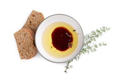Bowl of organic balsamic vinegar with oil, spices and bread isolated on white, top view