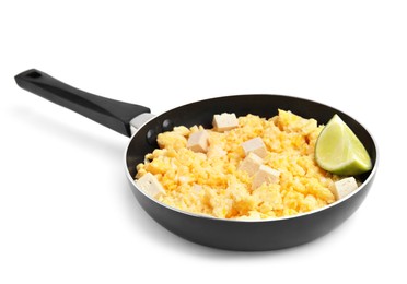 Photo of Frying pan with delicious scrambled eggs, tofu and lime isolated on white