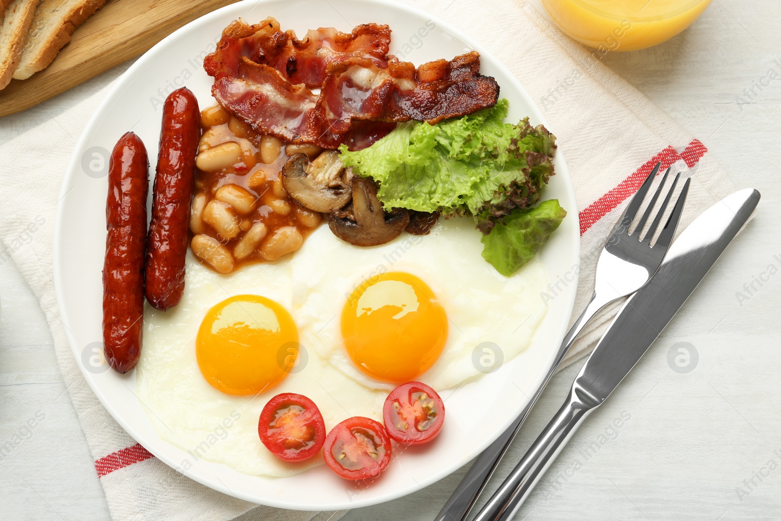 Photo of Delicious breakfast with sunny side up eggs served on white table, flat lay