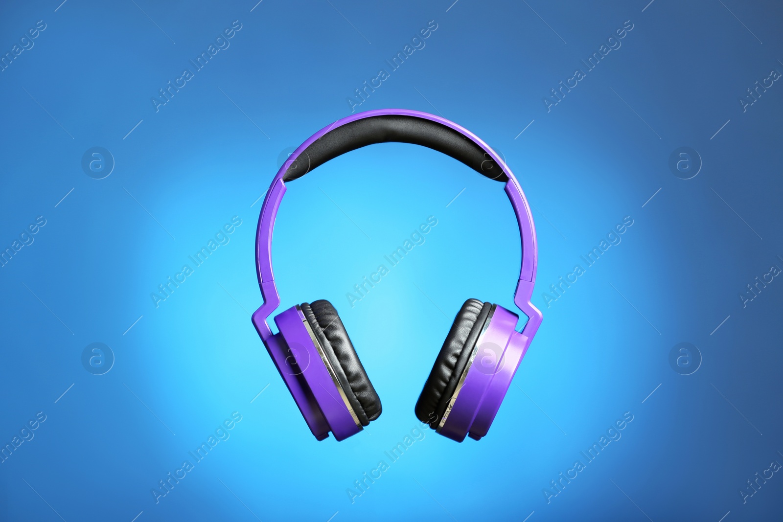 Photo of Stylish headphones with pads on color background