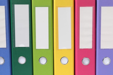 Photo of Bright binder office folders as background, closeup