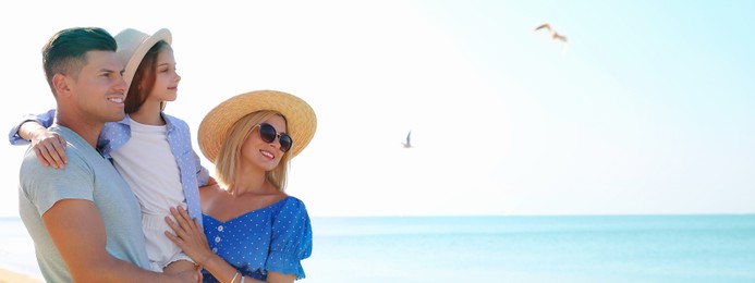 Happy family at beach on sunny summer day, space for text. Banner design