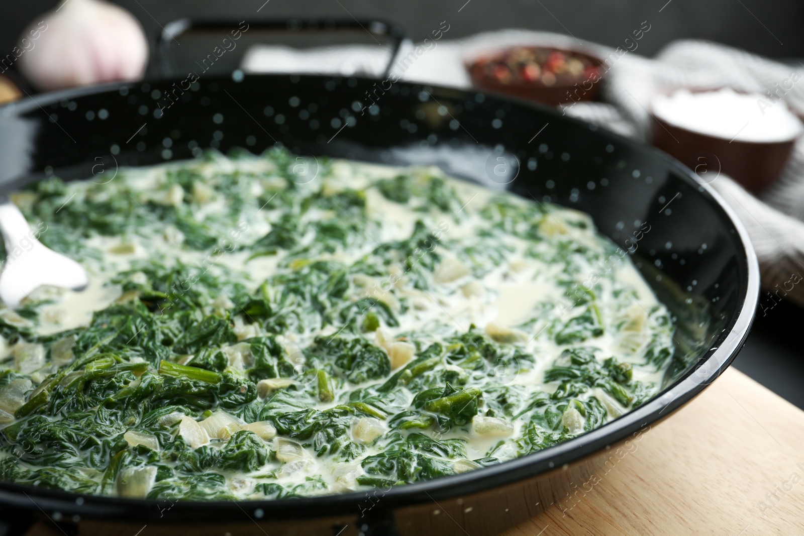 Photo of Tasty spinach dip in frying pan on table, closeup