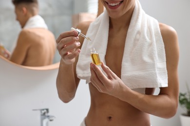 Photo of Man with serum in bathroom, closeup view